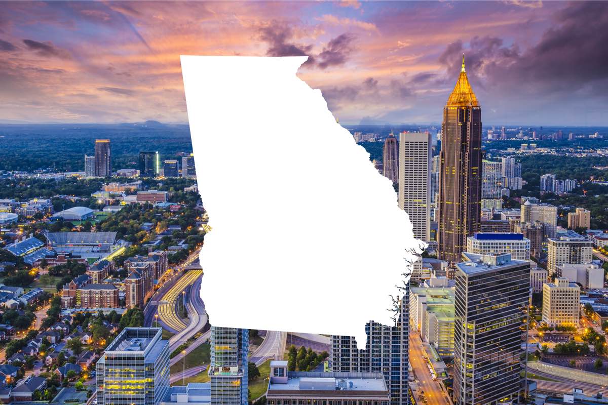 White graphic of state of Gerogia overlaid on Atlanta city view
